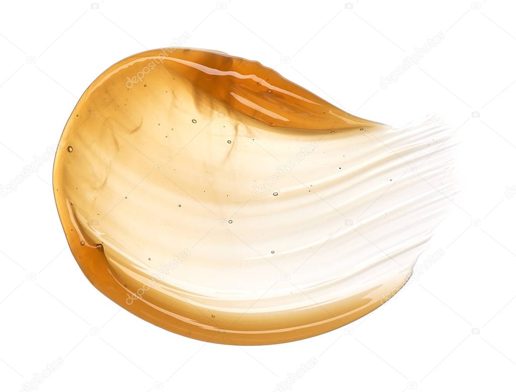 Transparent yellow smear of face cream or golden honey isolated on white background. Golden creamy honet texture on white background