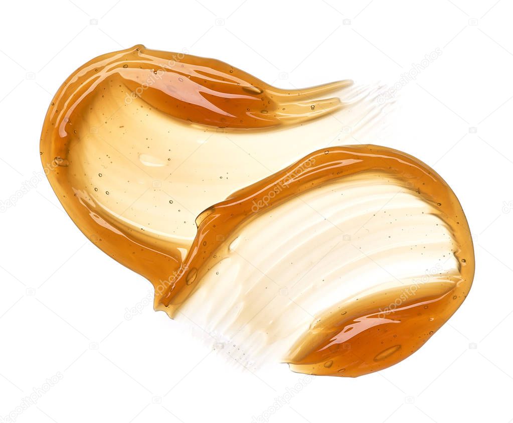 Transparent yellow smear of face cream or golden honey isolated on white background. Golden creamy honet texture on white background