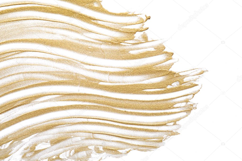Light beige makeup smear of creamy foundation isolated on white background. Golden creamy lipgloss texture on white background