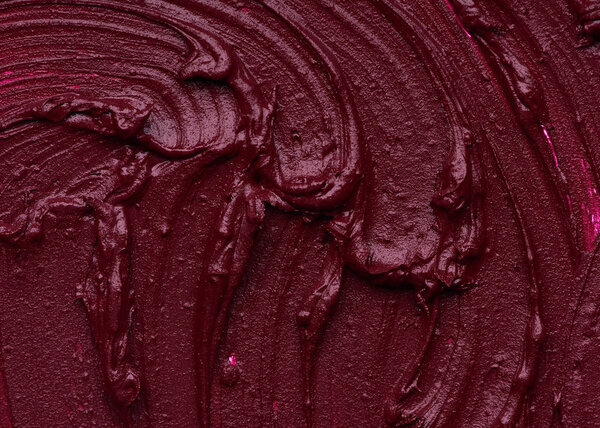 Dark red smear of matte lip gloss isolated on white background. Red creamy lipstick texture isolated on white background