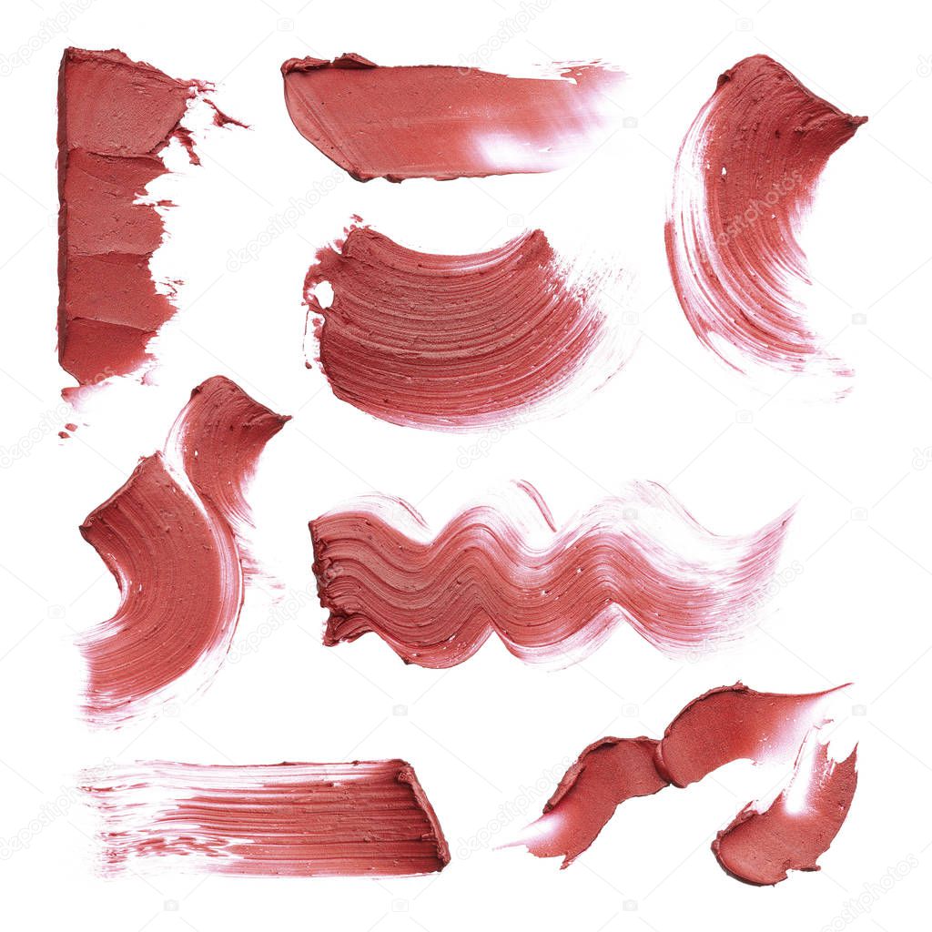 Smears of different colors are made by various cosmetic products isolated on a white background. Texture of multi-colored strokes of various make-up cosmetics on a white background