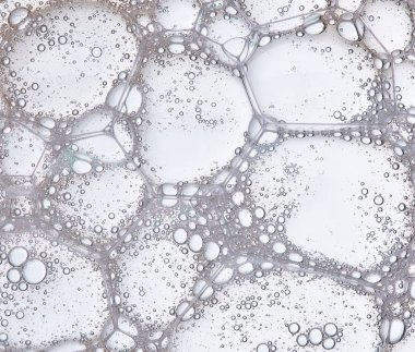 Full frame of the textures formed by the bubbles and drops in the shape of circle floating clipart