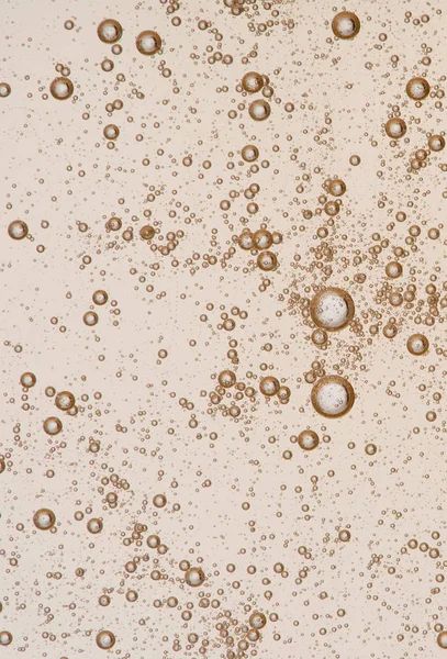 Full frame of the textures formed by the bubbles and drops of oil in the shape of circle floating