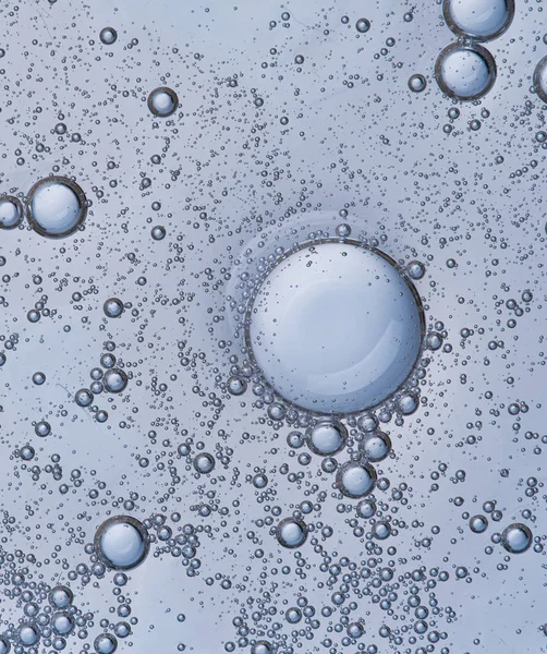 Full frame of the textures formed by the bubbles and drops of oil in the shape of circle floating