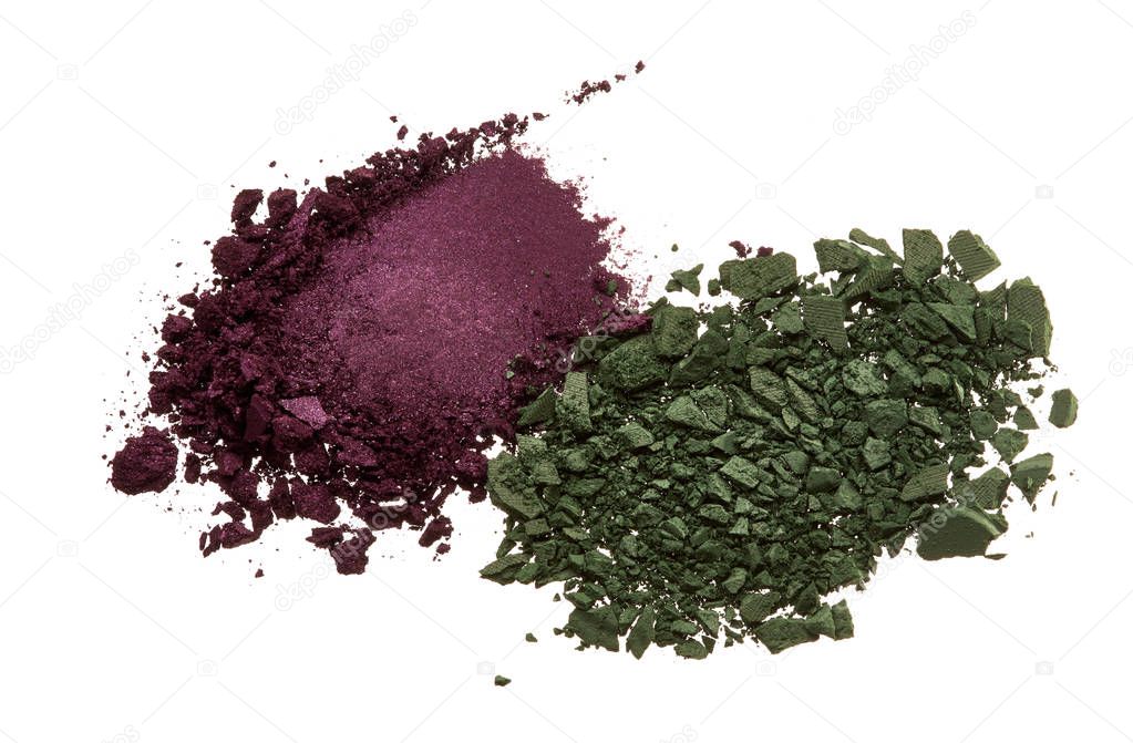 Various crushed up make-up powder and eye shadow products on white background