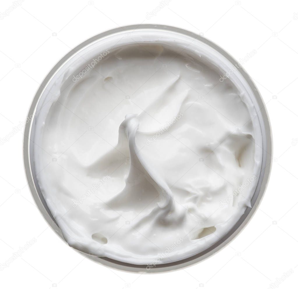 White beauty cream in a jar on a white background