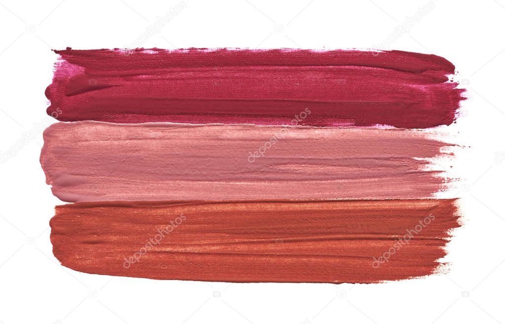 Three straight lines made by three different lipsticks isolated on white background. Lipstick texture isolated on white background