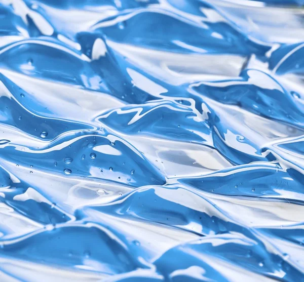 Esfregaços de loção aquosos e azuis claros — Fotografia de Stock