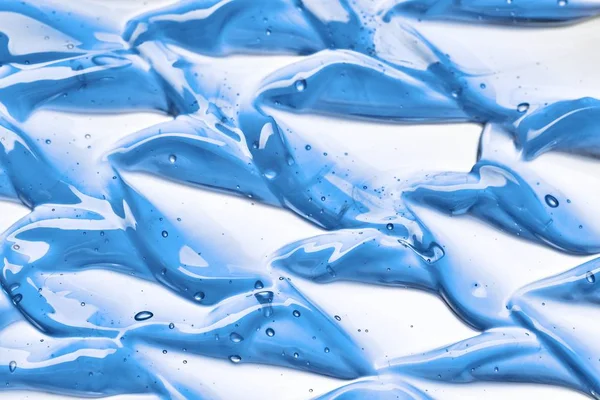 Licht blauw, waterig lotion uitstrijkjes — Stockfoto