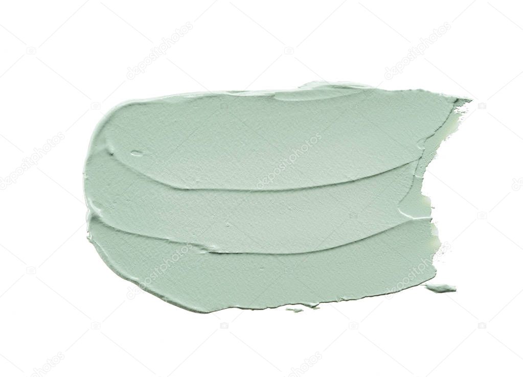 Gently green strokes and texture of face cream or acrylic paint isolated on white background