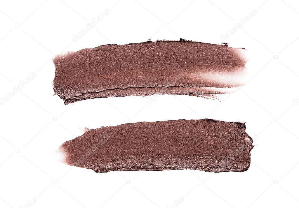 Brown strokes and texture of cream bronze eyeshadow or acrylic paint isolated on white background