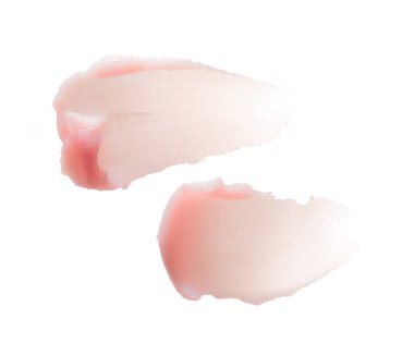 Kozmetik yüz maskesi ya da beyaz arkaplandaki kremin hassas pembe dokusu ve vuruşları