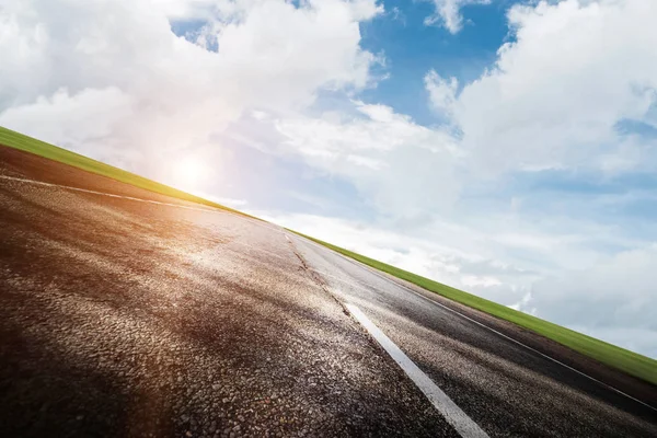 Summer road, sky, sun and clouds