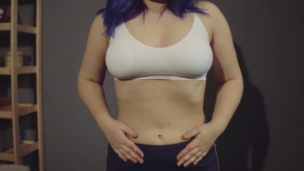 Sad overweight young woman pinching her fat on abdomen. — Stock Video