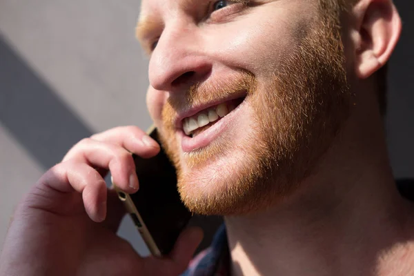 Handsome young man talking on phone. — Stock Photo, Image