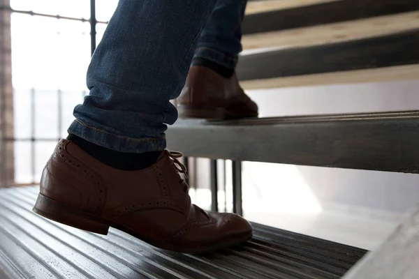 Young man walking up stairs.