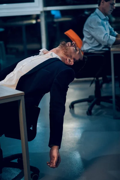 Businessman falling asleep during work.