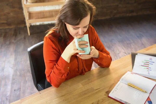 Деловая леди пьет кофе в офисе . — стоковое фото
