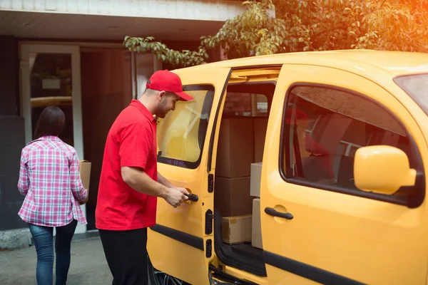 Delivery man closing van.