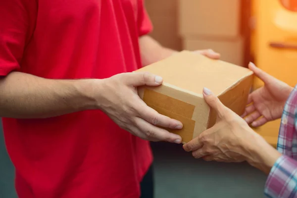 Delivery man handing package box.