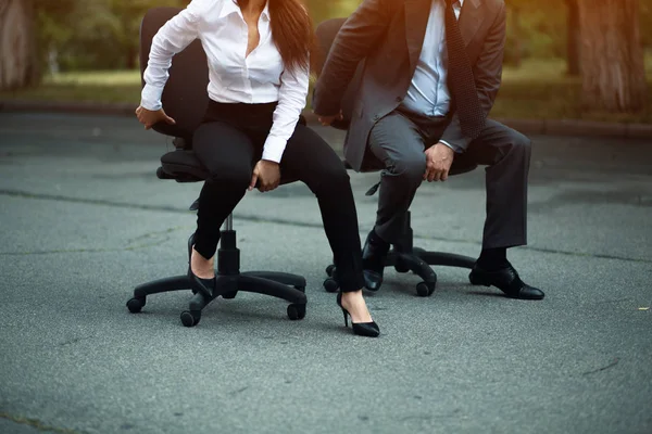 Businesspeople having racing on office chairs — Stock Photo, Image
