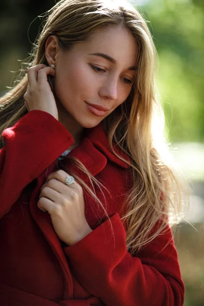 Mujer joven caminando usando abrigo rojo —  Fotos de Stock