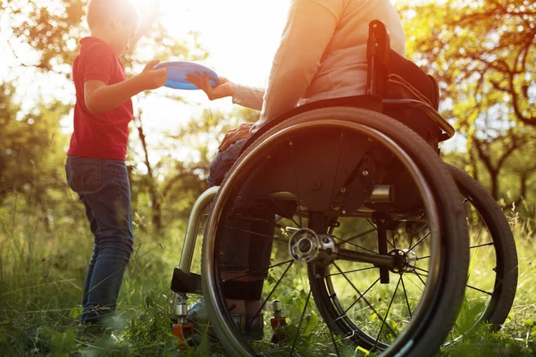 Close-up view on the wheels of a wheelchair. Bright — Stock Photo, Image