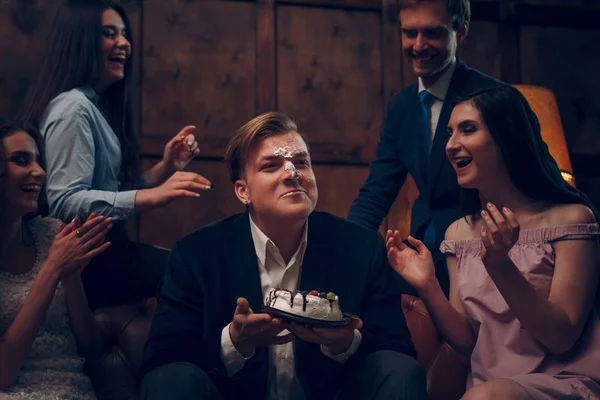 Handsome mans face covered in birthday cake — Stock Photo, Image