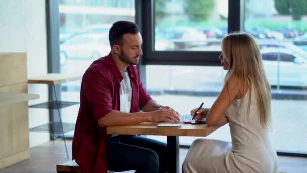 Young couple in love sitting in a cafe and having coffee — Stock Video