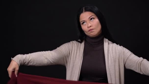 Beautiful woman thinks how to wear her scarf — Stock Footage Beautiful woman thinks how to wear her scarf Video Clip