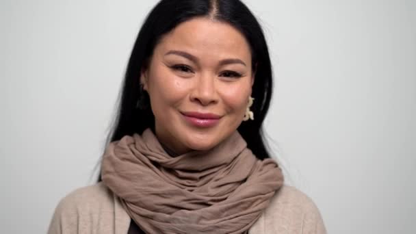 Asian Woman with a Gentle Smile on a White Background. — Stock Video