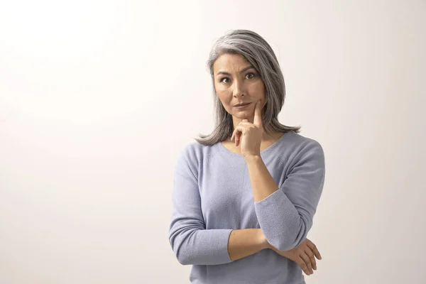 Asian woman smiling and pointing her finger to her cheek — Stock Photo, Image