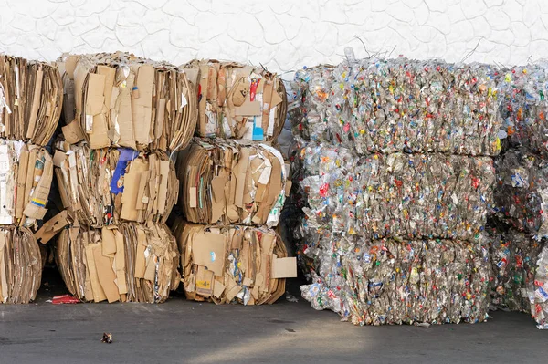 Pilas de cajas de cartón y botellas de plástico almacenadas para reciclar —  Fotos de Stock
