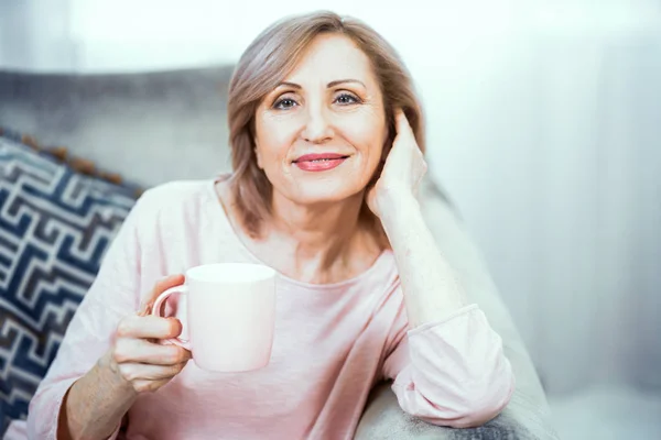 一个超过50年的妇女在家庭饮茶的欧洲外观休息. — 图库照片