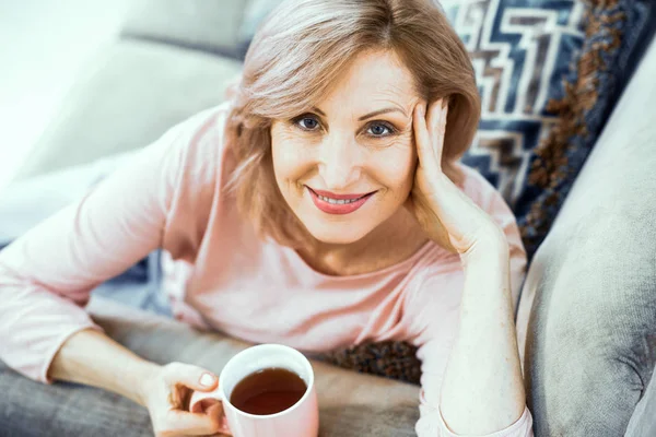 A Woman Over 50 Years of European Appearance Resting at Home Drinking Tea.