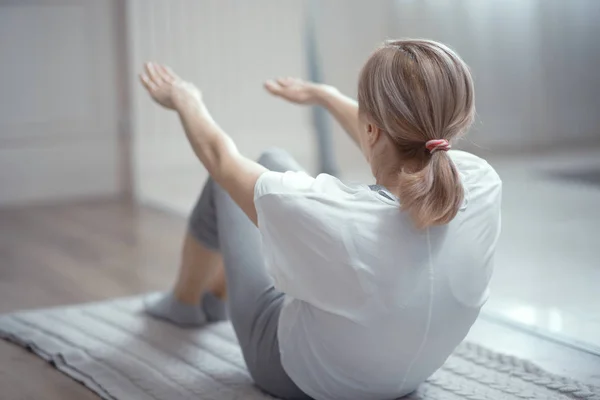 Schöne reife Frau macht Yoga-Presse-Übungen — Stockfoto