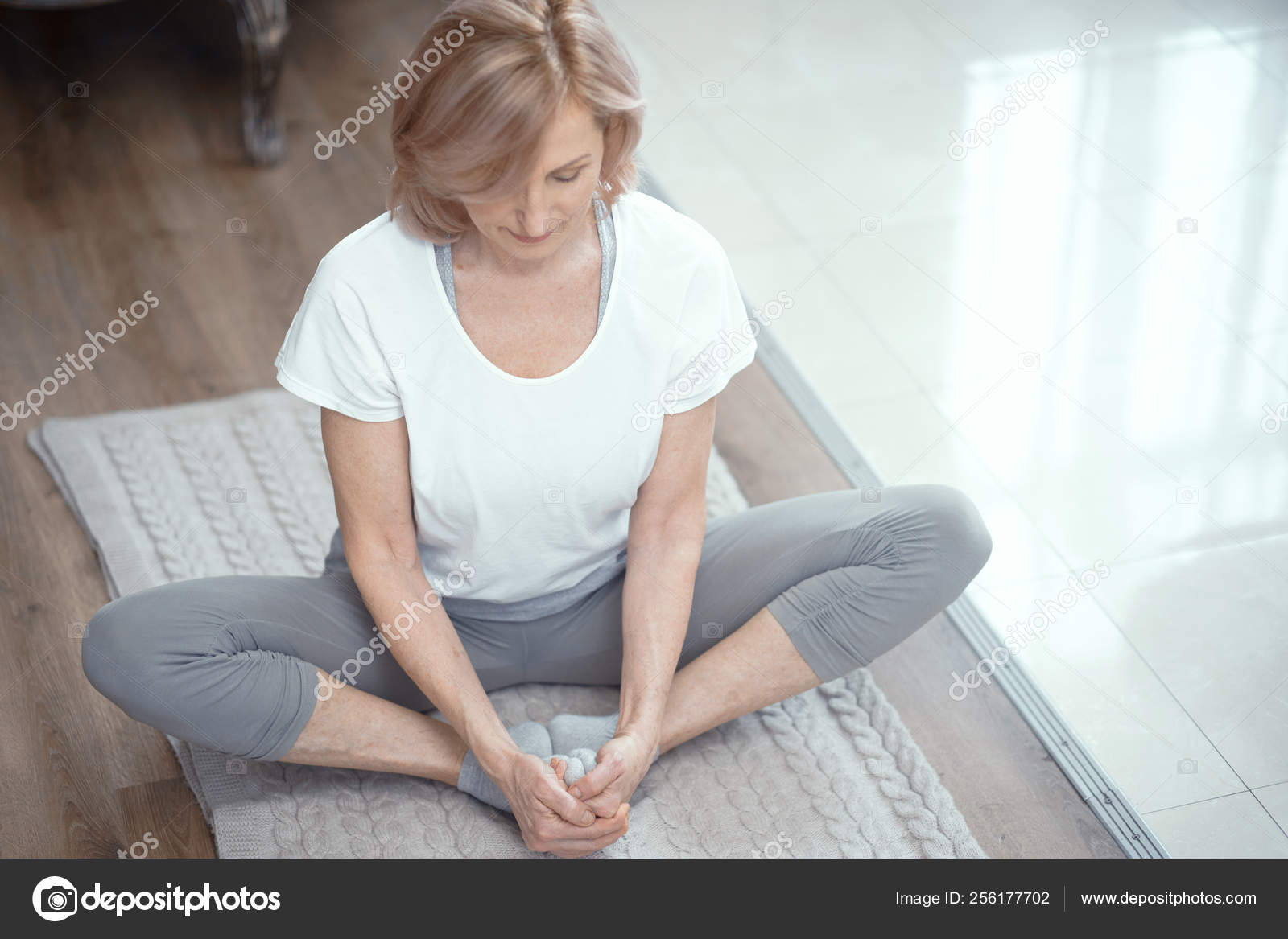 A Beautiful Young Chinese Asian Oriental Woman Sitting Cross Legged In A Yoga  Position At A Gym Stock Photo, Picture and Royalty Free Image. Image  11148535.