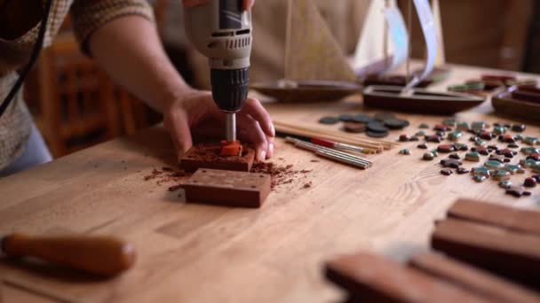 Carpenter używa Wiertarki obrotowej narzędzia o wyrzeźbić drewnianą deskę — Wideo stockowe