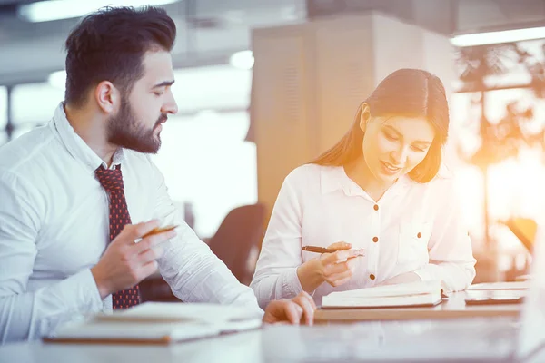 Un par de colegas en el escritorio en la oficina soleada — Foto de Stock