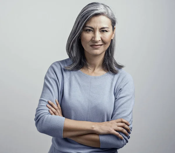 Asian senior woman with crossed arms shows dissproval — Stock Photo, Image