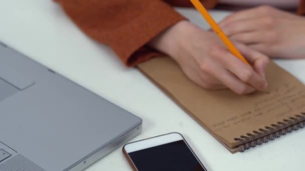 Appunti di scrittura della donna d'affari di close-up in taccuino. Donna sul posto di lavoro — Video Stock