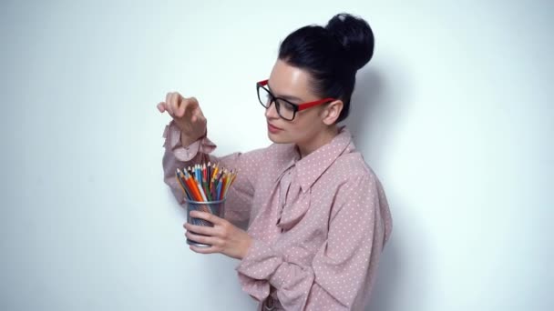 Офисная девушка в ателье с набором карандашей разных цветов — стоковое видео