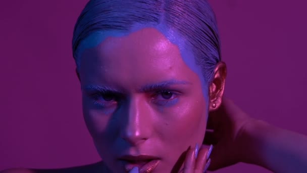 Mooie vrouwelijke model poseren in blauw en roze neon licht in Studio — Stockvideo