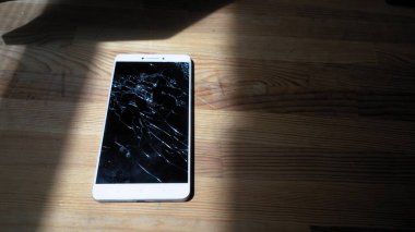 Xiaomi MI Max broken phone between shadows with shining fractures clipart