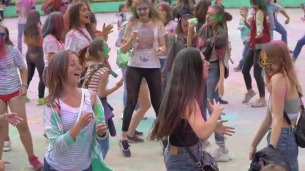 Мальчики и девочки отдыхают на фестивале красок — стоковое видео