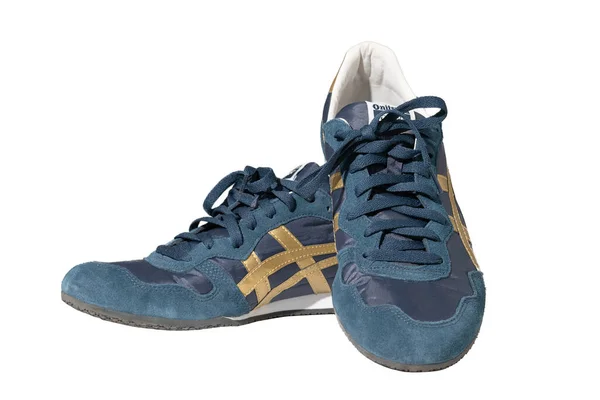 Coppia di sneakers blu del marchio Asics. Calzature in pelle con accenti dorati. Marchio Onitsuka Tiger. Moderne scarpe leggere con lacci. Isolato su sfondo bianco. Concetto sportivo. Maggio 2019. Kiev — Foto Stock