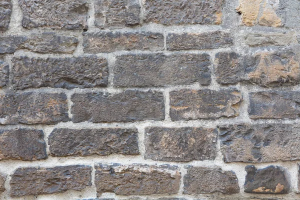Кирпичная стена старого здания. Старинная кирпичная каменная стена текстуры или фона. Каменная кладка или кирпичная кладка античной конструкции. Абстрактная текстура или фон. Крупный план — стоковое фото