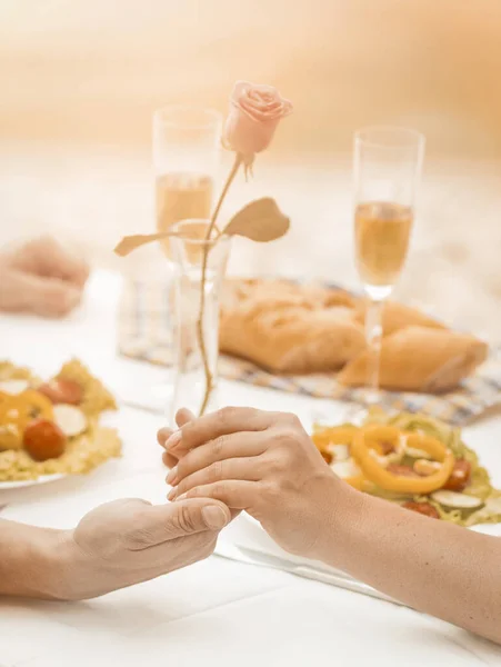 Romantic couple holding hands. Selective focus on Caucasian male and female hands holding together in foreground. Close up. Tinted image — Stock Photo, Image