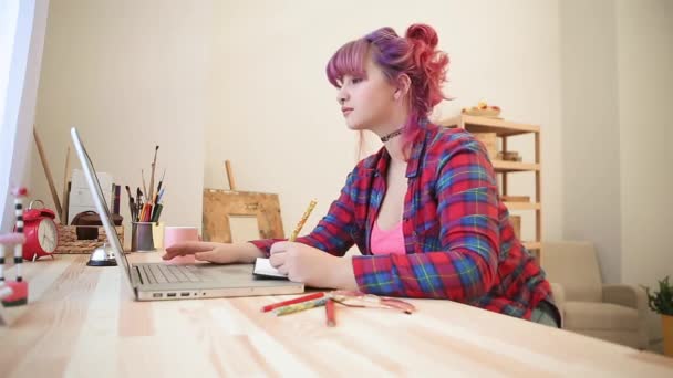 Creative freelancer girl siting at the desk with laptop at home, young adult girl getting ready for exams, beautiful girl study at home during quarantine days. Prores 422 — Stock Video