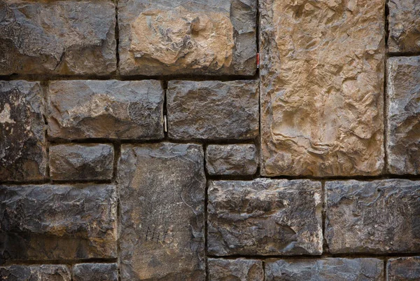 Old brick or stone wall. Antique brown wall different size brick masonry. Vintage texture or background — Stock Photo, Image